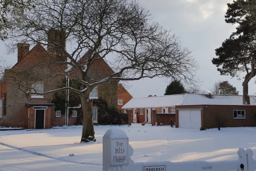 A red brick house in the snow