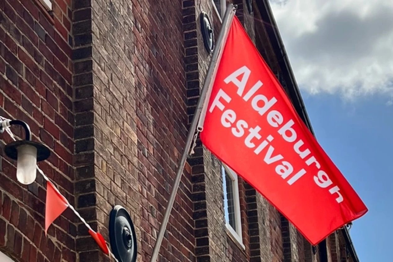 A red flag with 'Aldeburgh Festival' written across it