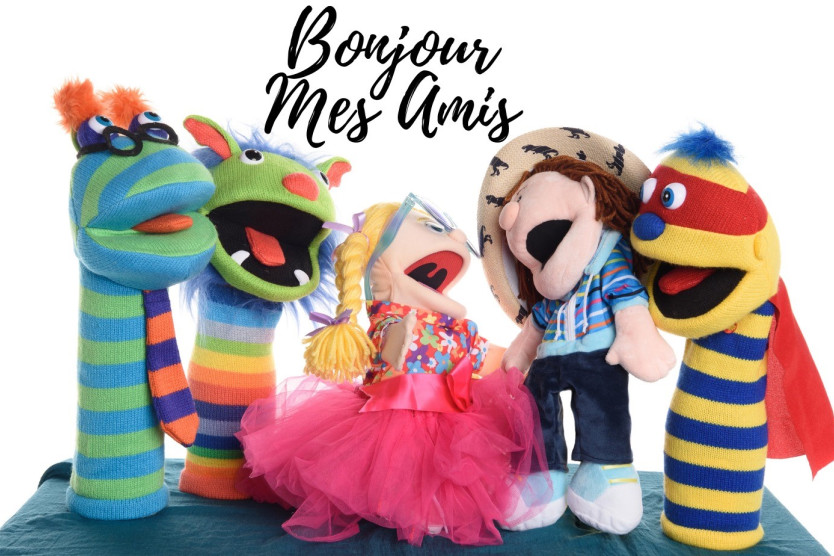 Five puppets, all brightly colours, with 'Bonjour Mes Amis' written across the top